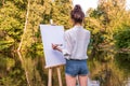 girl artist view from back, woman draws a picture, summer park lake pond river, creating creativity artistic mood. Blank