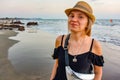 A girl on Ashvem beach with yellow sand, blue ocean and waves. Sunset of North Goa, India 2020 Royalty Free Stock Photo