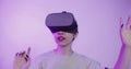 Asian girl puts on virtual reality glasses and begins to see in 5D attraction