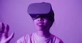 Asian girl puts on virtual reality glasses and begins to see in 5D attraction