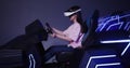 Asian girl in virtual reality glasses drives a car in 5D