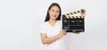 Girl or asian woman is holding black clapper board or movie slate or clapboard use in video production ,film, movie,cinema Royalty Free Stock Photo