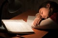 Girl asleep at a table doing homework