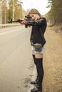 Girl assassin waiting for his victim on the road. Royalty Free Stock Photo