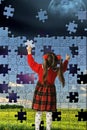 The girl assemble big puzzle Royalty Free Stock Photo