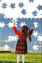 The girl assemble big puzzle Royalty Free Stock Photo