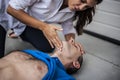 Girl assisting an unconscious man Royalty Free Stock Photo