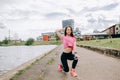 Girl athlete does squats in nature exercises for the buttocks. Young woman go in for sports healthy lifestyle athletic body.