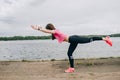 Girl athlete does squats in nature exercises for the buttocks. Young woman go in for sports healthy lifestyle athletic body.