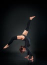 Girl athlete gymnast performing acrobatic elements jumping on a