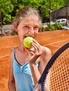 Girl athlete with racket and ball on brown