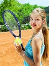 Girl athlete with racket and ball on tennis