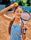 Girl athlete with racket and ball on tennis