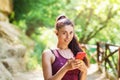 Girl athlete before training chooses music on a smartphone