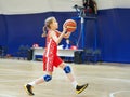 Girl athlete in uniform playing basketball