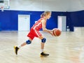 Girl athlete in uniform playing basketball