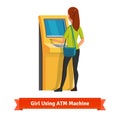 Girl at ATM machine doing deposit or withdrawal