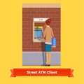 Girl at ATM machine doing deposit or withdrawal