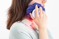 A girl attaches a medical bag with cold to the swelling on her cheek after removing a wisdom tooth. Concept for pain relief and