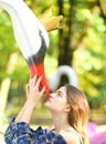 Girl with attentive face looks up. Woman and swan