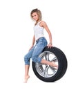 Girl with automobile tyres Royalty Free Stock Photo