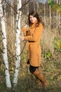 Girl in autumn day among young trees Royalty Free Stock Photo