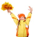 Girl in autumn orange hat holding leaves .