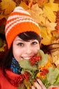 Girl in autumn orange hat on leaf group. Royalty Free Stock Photo