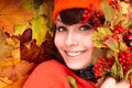 Girl in autumn orange hat on leaf group. Royalty Free Stock Photo