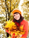 Girl in autumn orange hat , leaf group near tree. Royalty Free Stock Photo