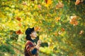 Girl in autumn orange leaves. Autumn leaves falling on happy young woman in forest. Fall concept. Fall. Autumn girl Royalty Free Stock Photo