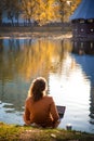 girl in autumn park near the water