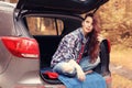 Girl at autumn trip by car