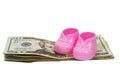 Girl Baby Booties Sitting on a Stack of Money With Shadows Royalty Free Stock Photo