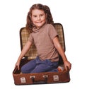 Girl baby brunette sitting in a suitcase for travel isolated on Royalty Free Stock Photo