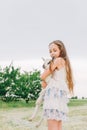 Girl with baby goat on farm outdoors. Love and care. Village animals. happy child hugs goat, concept of unity of nature Royalty Free Stock Photo