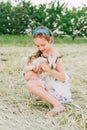 Girl with baby goat on farm outdoors. Love and care. Village animals. happy child hugs goat, concept of unity of nature Royalty Free Stock Photo