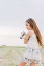 Girl with baby goat on farm outdoors. Love and care. Village animals. happy child hugs goat, concept of unity of nature Royalty Free Stock Photo