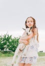 Girl with baby goat on farm outdoors. Love and care. Village animals. happy child hugs goat, concept of unity of nature Royalty Free Stock Photo