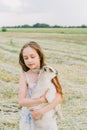 Girl with baby goat on farm outdoors. Love and care. Village animals. happy child hugs goat, concept of unity of nature Royalty Free Stock Photo