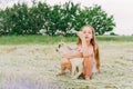 Girl with baby goat on farm outdoors. Love and care. Village animals. happy child hugs goat, concept of unity of nature Royalty Free Stock Photo