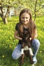 Girl and baby goat in flowered garden Royalty Free Stock Photo