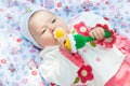 Girl baby a rattle played outdoors Royalty Free Stock Photo