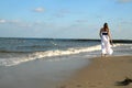 girl, back, goes on an empty beach