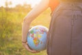 A girl with backback holding globe Royalty Free Stock Photo