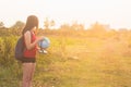 A girl with backback holding globe Royalty Free Stock Photo