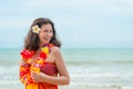 Girl on the background of the sea in pareo and traditional Hawaiian Lei Royalty Free Stock Photo