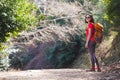 A girl with a backpack goes along a mountain trail Royalty Free Stock Photo