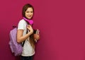 Girl with backpack hold books isolated on colour background studio portrait. Childhood lifestyle concept. Education in school. Royalty Free Stock Photo