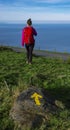 Girl with a backpack on Mount with an arrow of the Northern Satiago Road camino de Santiago Royalty Free Stock Photo